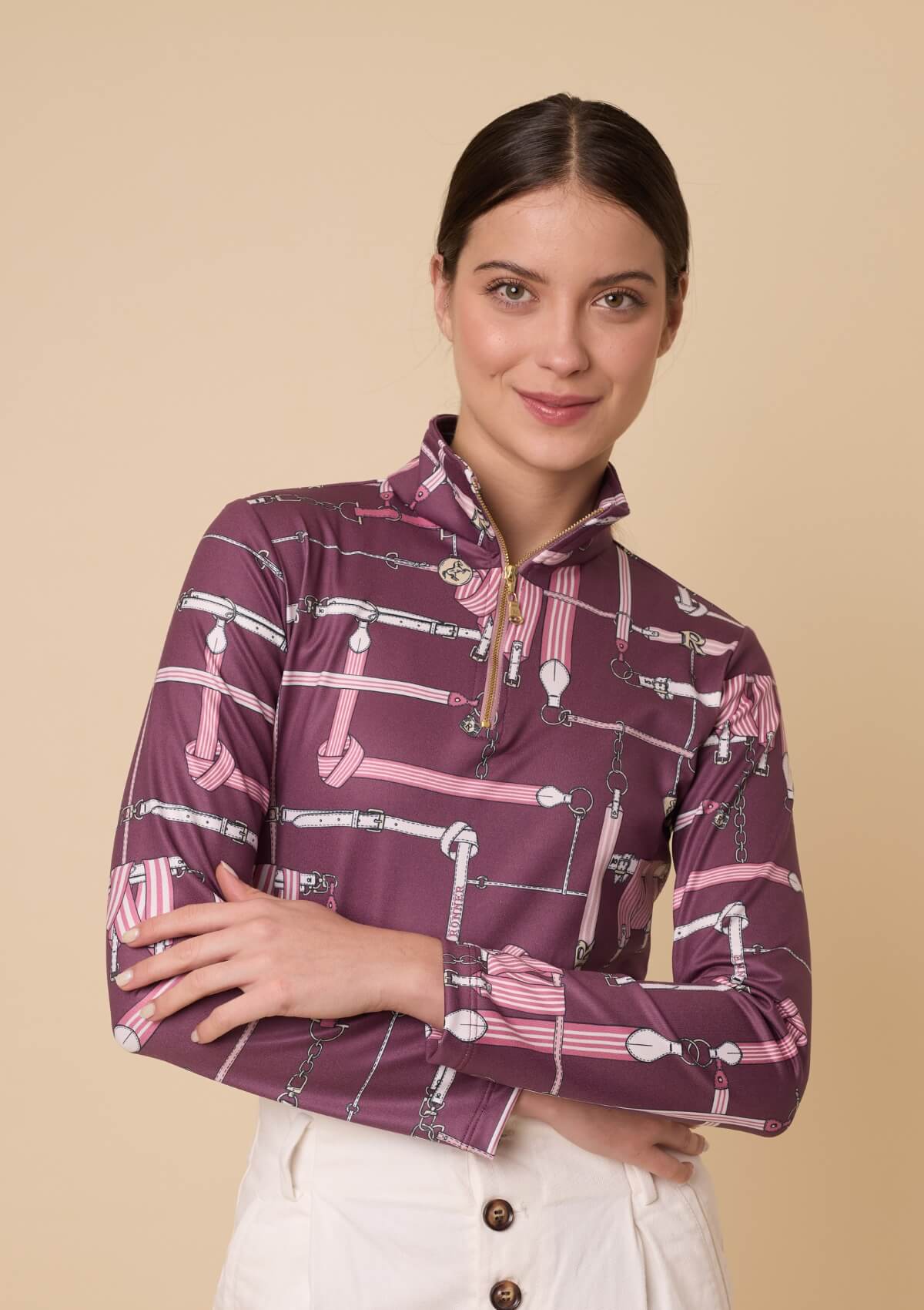 Woman wearing a patterned shirt with a beige background