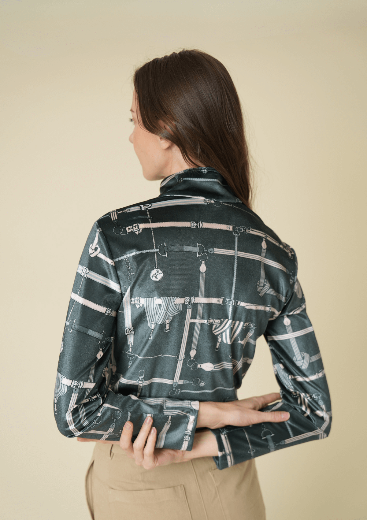 Woman wearing a patterned shirt with a beige background