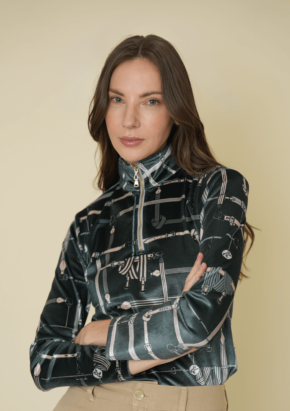 Woman wearing a patterned shirt against a beige background