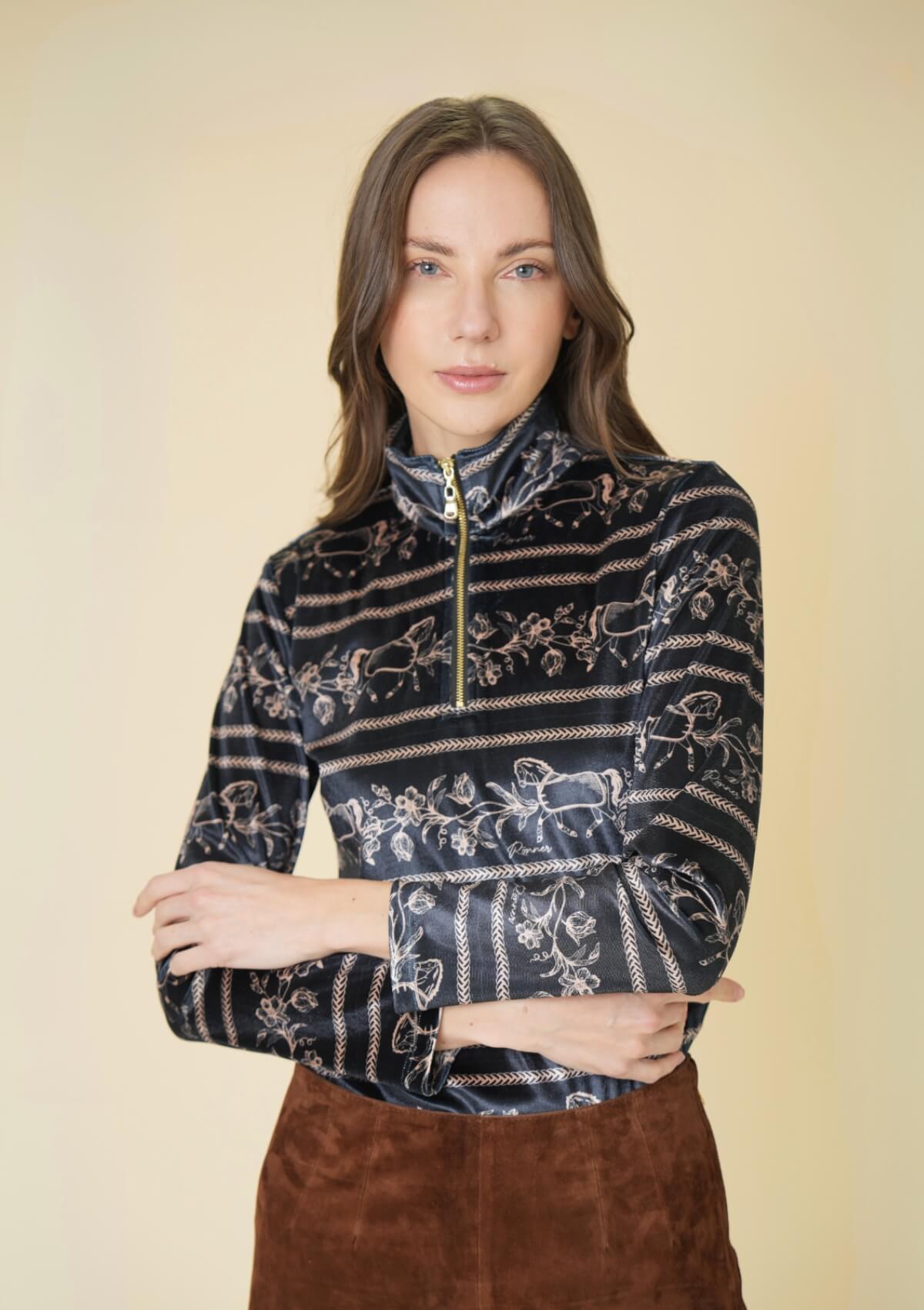 Woman wearing a patterned half-zip sweater against a beige background